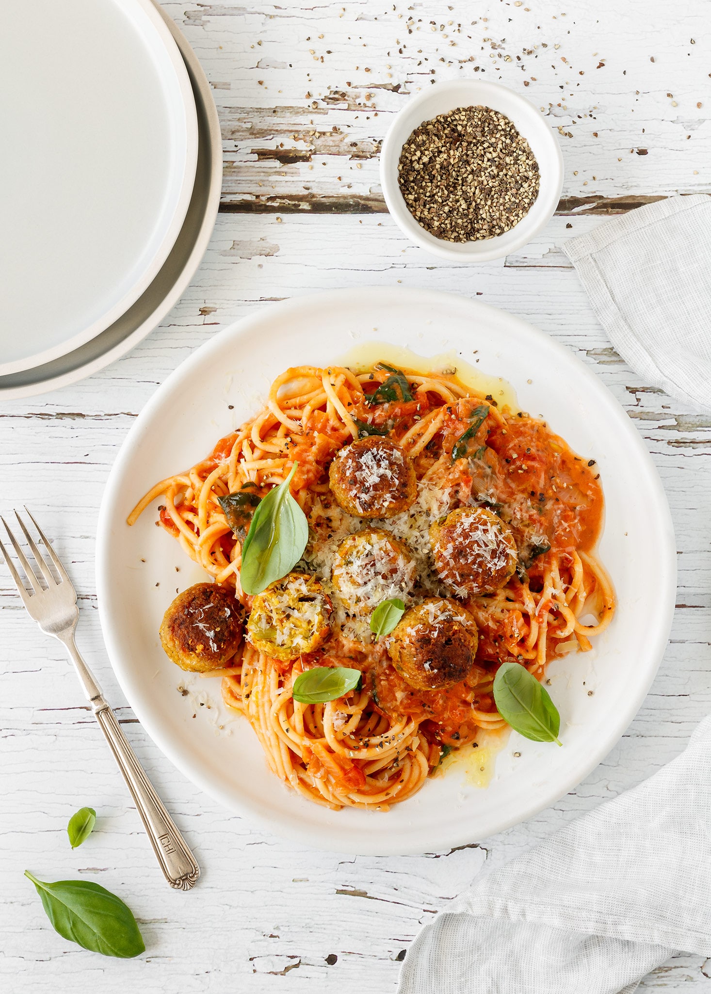 Spaghetti and veggie balls with creamy tomato sauce, parmesan and basil.