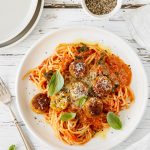 Spaghetti and veggie balls with creamy tomato sauce, parmesan and basil.