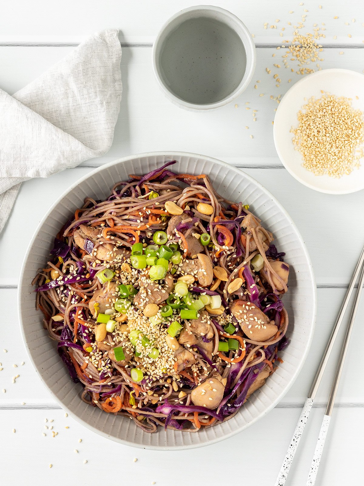 Teriyaki chicken noodles with peanuts, sesame seeds and spring onions.