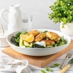 Cheesy corn poppers on salad with sweet chilli vinaigrette and lemon.