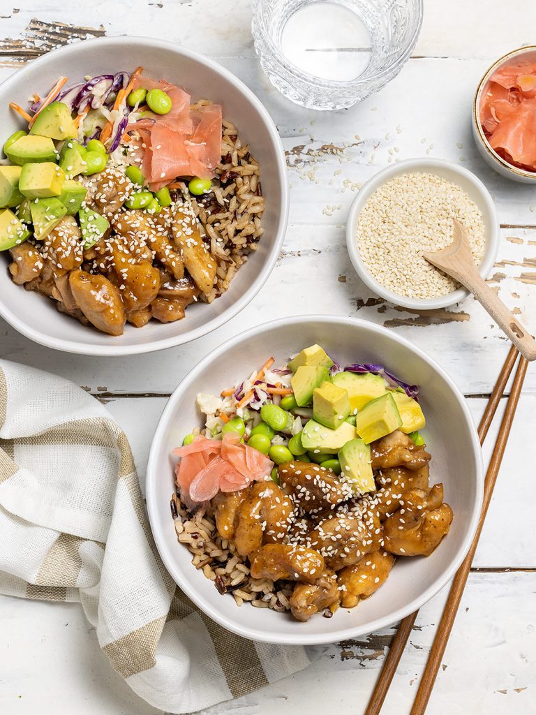 Chicken sushi bowls on rice with creamy Asian slaw, edamame beans, avocado and pickled ginger.